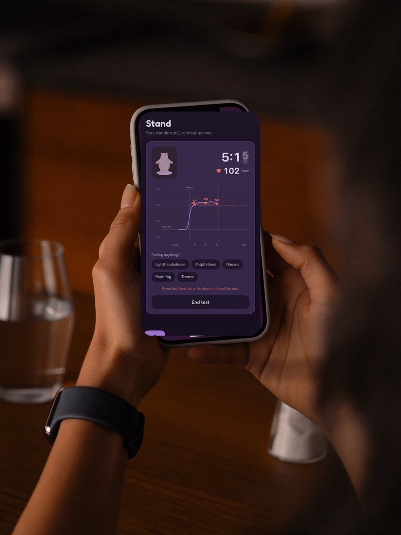 Hands holding a phone running Orsa, smartwatch on the wrist